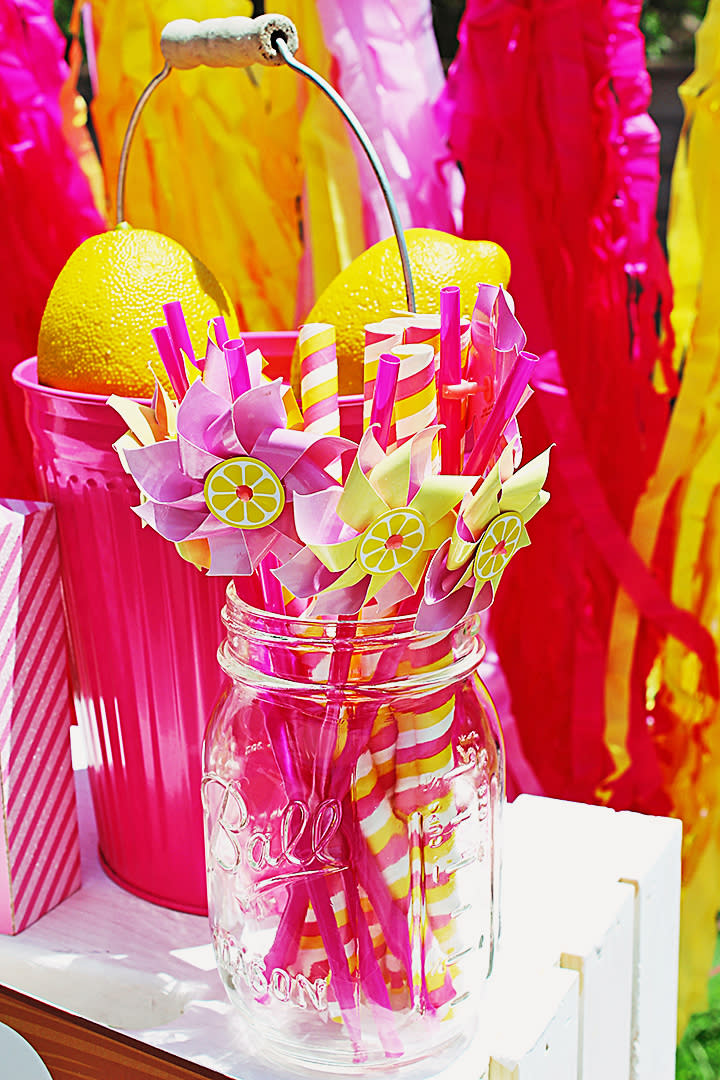 mason jar filled with colorful straws and pinwheels