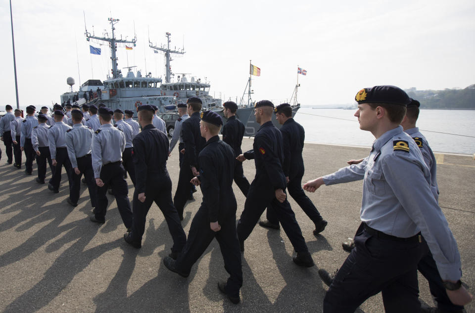 Crew members of Belgian minehunter Belis march towards their ship to set sail together with four other ships of the Netherlands, Norway and Estonia from Kiel, Germany, Tuesday, April 22, 2014. The warships are part of the standing NATO Mine Counter-Measures Group ONE, one of NATO’s four standing Maritime Forces, deploying to the Baltic Sea to enhance maritime security and readiness in the region. The maritime Group was reactivated by a North Atlantic Council decision to enhance collective defense and assurance measures in response to the crisis in Ukraine. (AP Photo/Gero Breloer)