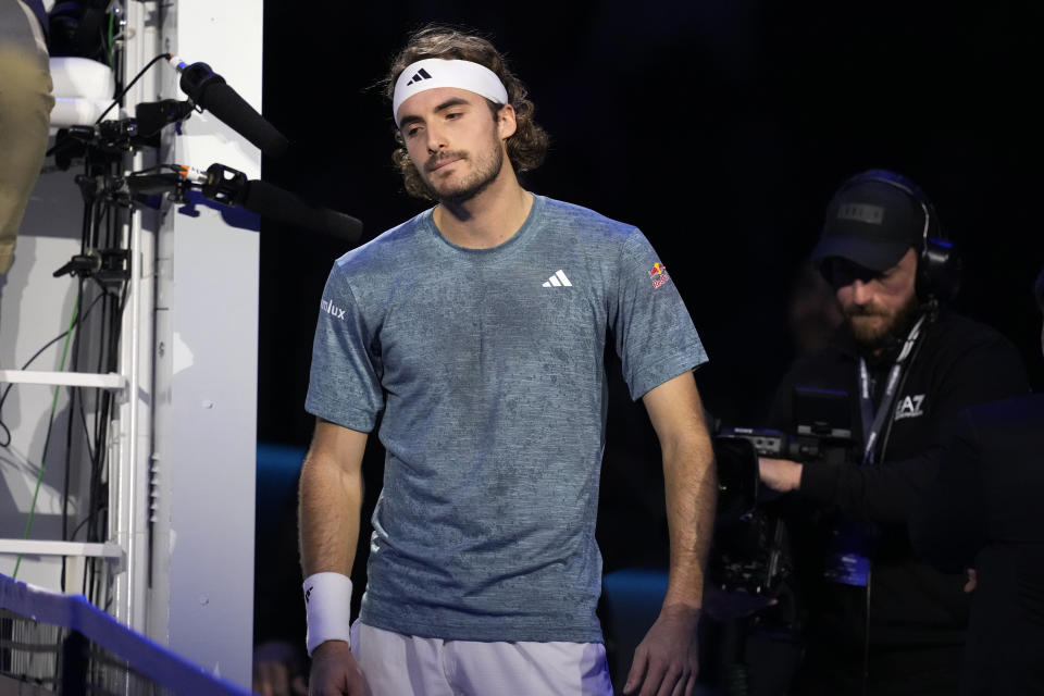 Greece's Stefanos Tsitsipas leaves the pitch after injuring during the singles tennis match against Denmark's Holger Rune, of the ATP World Tour Finals at the Pala Alpitour, in Turin, Italy, Tuesday, Nov. 14, 2023. (AP Photo/Antonio Calanni)