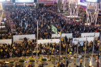 FILE - In this Jan. 31, 2020, file photo, fans gather at a memorial for Kobe Bryant in front of Staples Center, prior to an NBA game between the Los Angeles Lakers and the Portland Trail Blazers in Los Angeles. A person with knowledge of the details says a public memorial service for Bryant, his daughter and seven others killed in a helicopter crash is planned for Feb. 24 at Staples Center. The Los Angeles arena is where Bryant starred for the Lakers for most of his two-decade career. The date corresponds with the jersey numbers he and 13-year-old daughter Gianna wore, 24 for him and 2 for her. (AP Photo/Ringo H.W. Chiu, File)