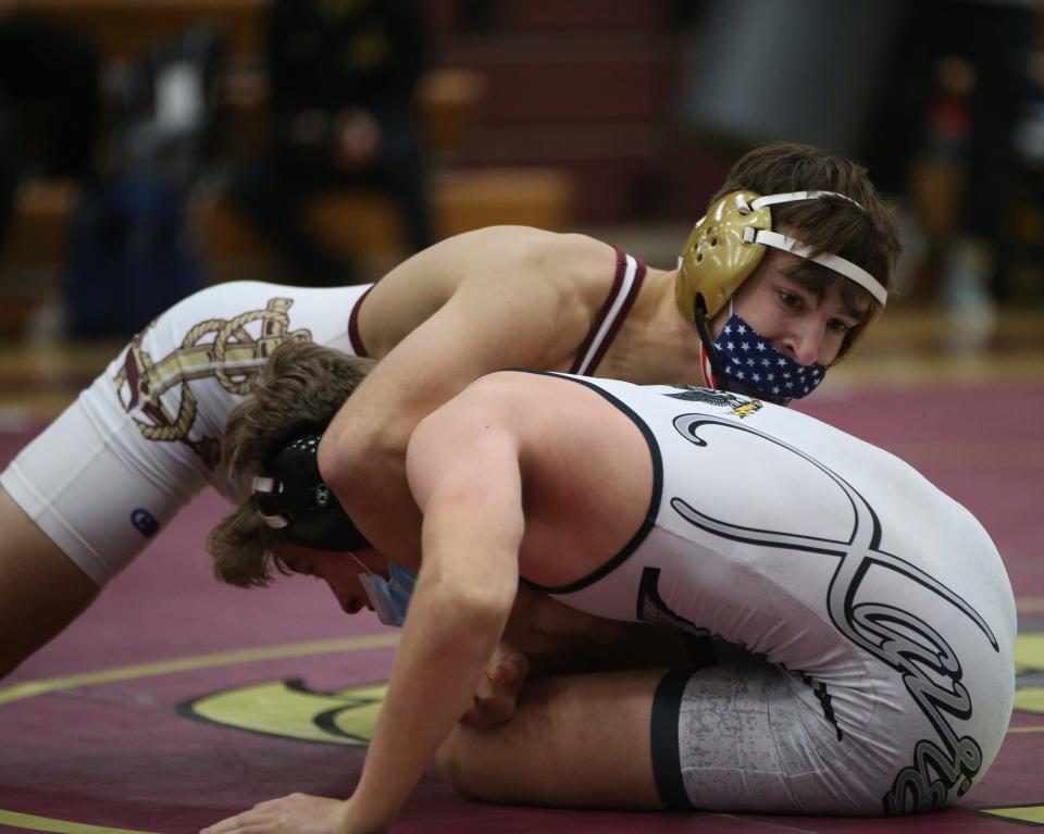 From left, Arlington's Tim Bova wrestles against Xavier's Colin Loria during the championship match for the 152lb weight class during the Mid Hudson Wrestling Tournament in Freedom Plains on December 28, 2021. Bova won by fall. 