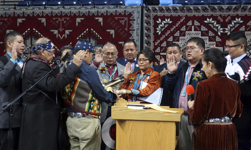 Navajo Nation Council delegates take the oath of office Tuesday, Jan. 15, 2019, in Fort Defiance, Ariz. (AP Photo/Felicia Fonseca)