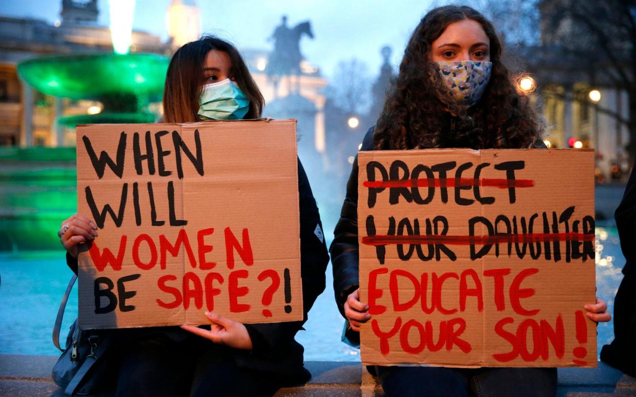 Young women hold up signs asking 'When will women be safe?' - Getty Images/Hollie Adams