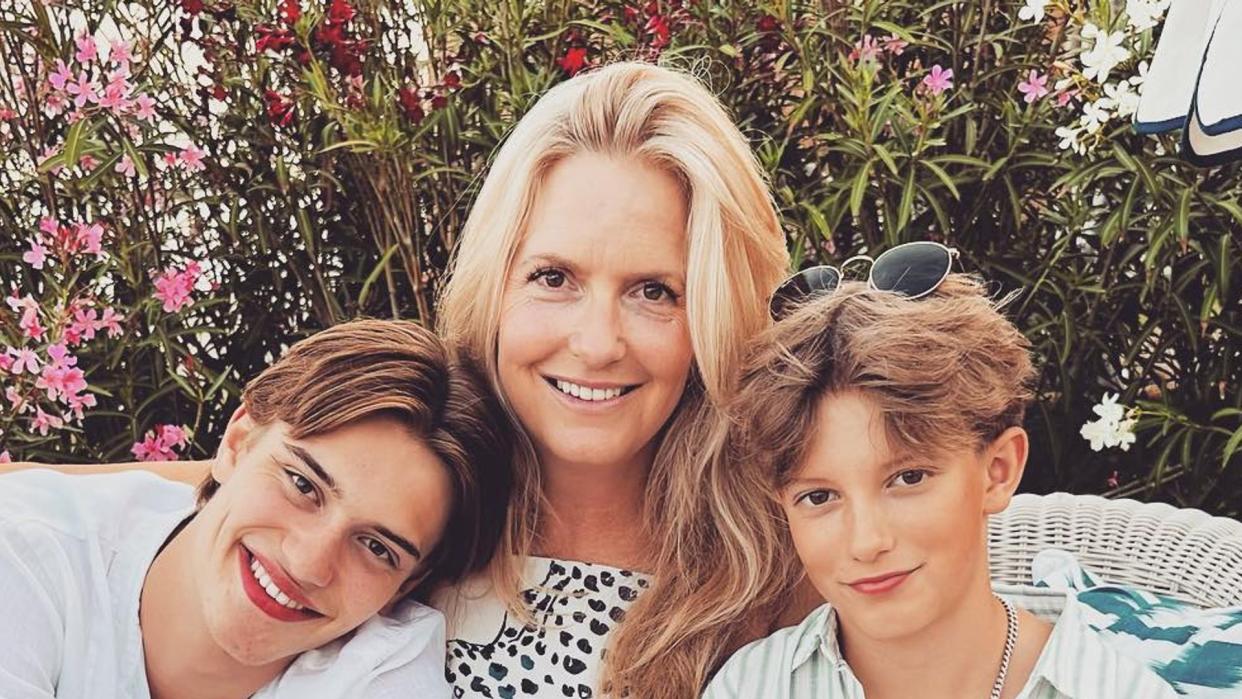 mother posing with two sons during summer