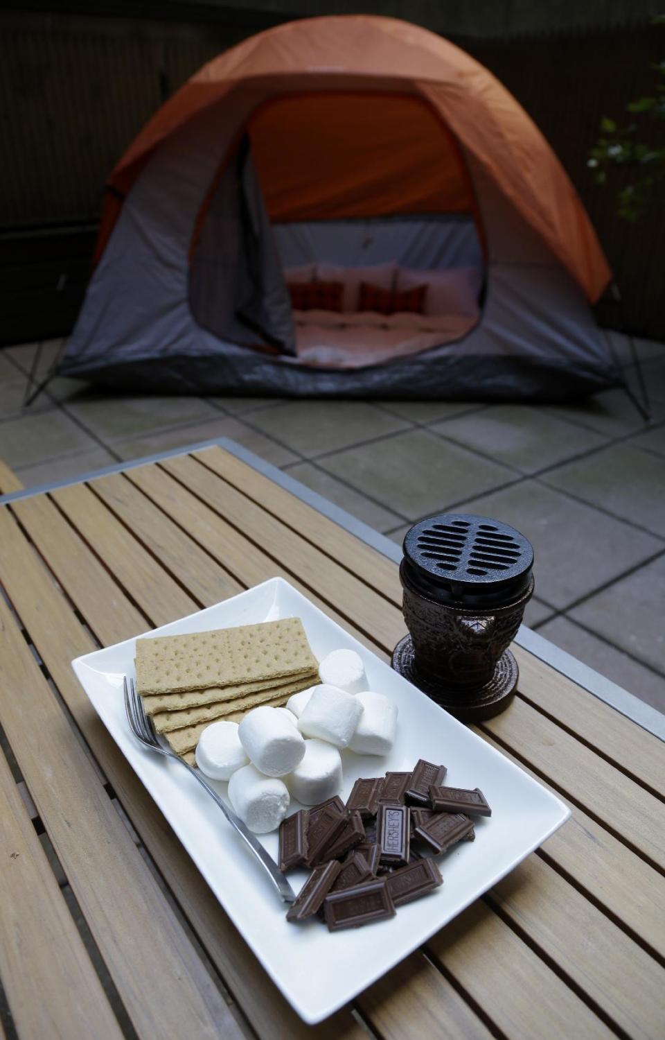 Along with a tent on your patio, smores are an option at the Affina Hotel in New York, Thursday, Aug. 15, 2013. A couple of New York City locales are offering an unusual option _ the chance to sleep outdoors, incredibly comfortably. It’s an urban take on “glamping,” where hotel comforts are taken outside. (AP Photo/Seth Wenig)