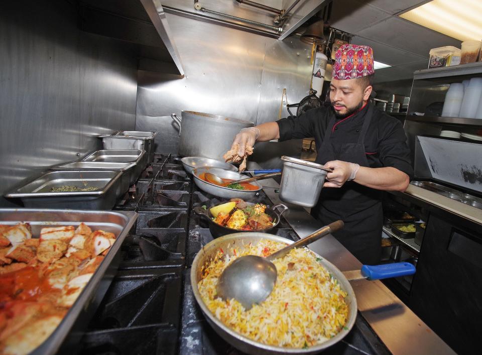 Sous Chef Aakash Gautamey prepares dishes for lunch on Thursday, March 7, 2024, at the Turmeric House in Weymouth.