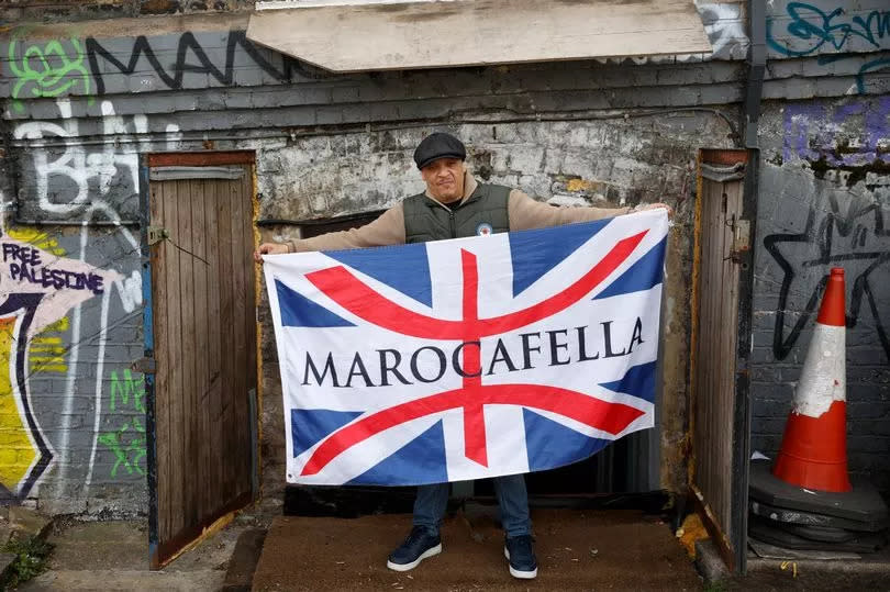 Tarik Kamhouri holding up a Marocafella union jack flag
