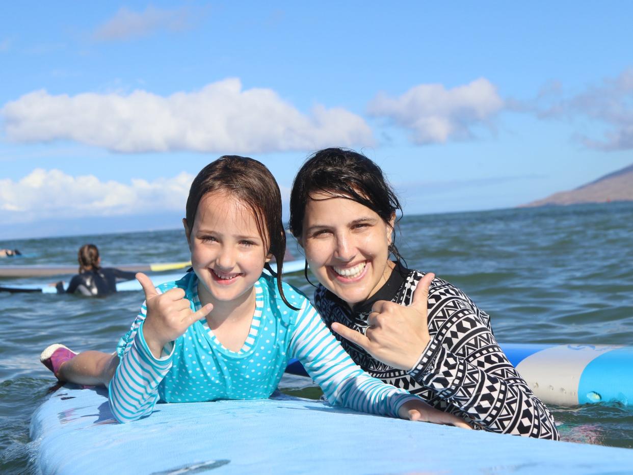 Mother and daughter surfing