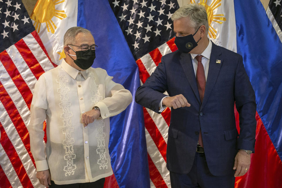 U.S. National Security Advisor Robert O'Brien, right, and Philippine Foreign Secretary Teodoro Locsin Jr. elbow bump after the turnover ceremony of defense articles at the Department of Foreign Affairs in Pasay City, Metro Manila, Philippines, Monday, Nov. 23, 2020. (Eloisa Lopez/Pool Photo via AP)