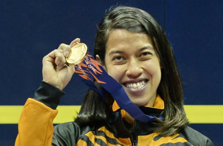 Malaysia's Nicol David poses with her gold medal after defeating compatriot Wee Wern Low in the women's squash final match, at Yeomurul squash courts during the 2014 Asian Games in Incheon