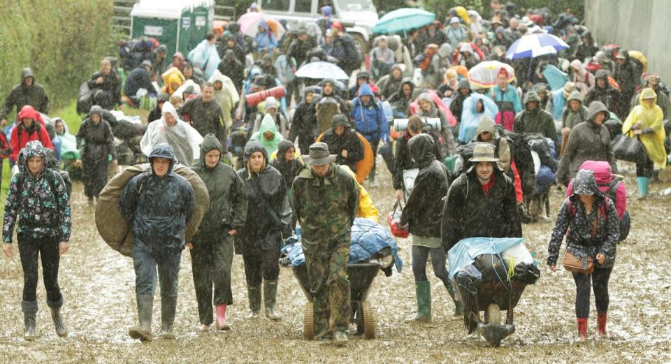 Festival goers arriving at the Glastonbury Festival in 2011 (Yui Mok/PA) (PA Archive)