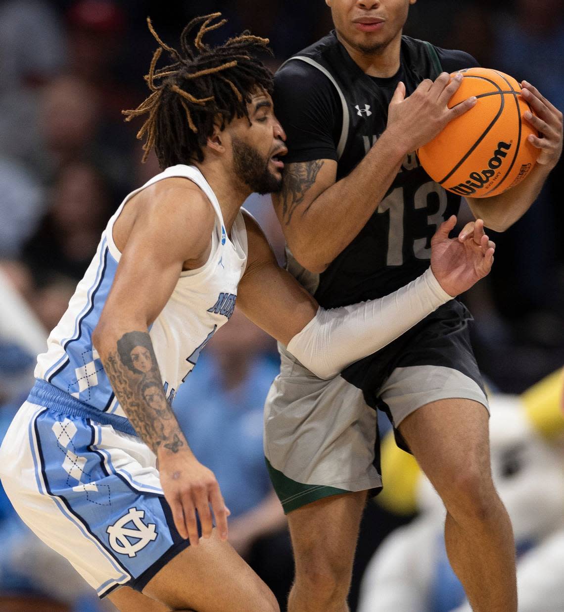 North Carolina’s R.J. Davis (4) defends Wagner’s Julian Brown (13) in the first half on Thursday, March 21, 2024 during the NCAA Tournament at Spectrum Center in Charlotte, N.C.