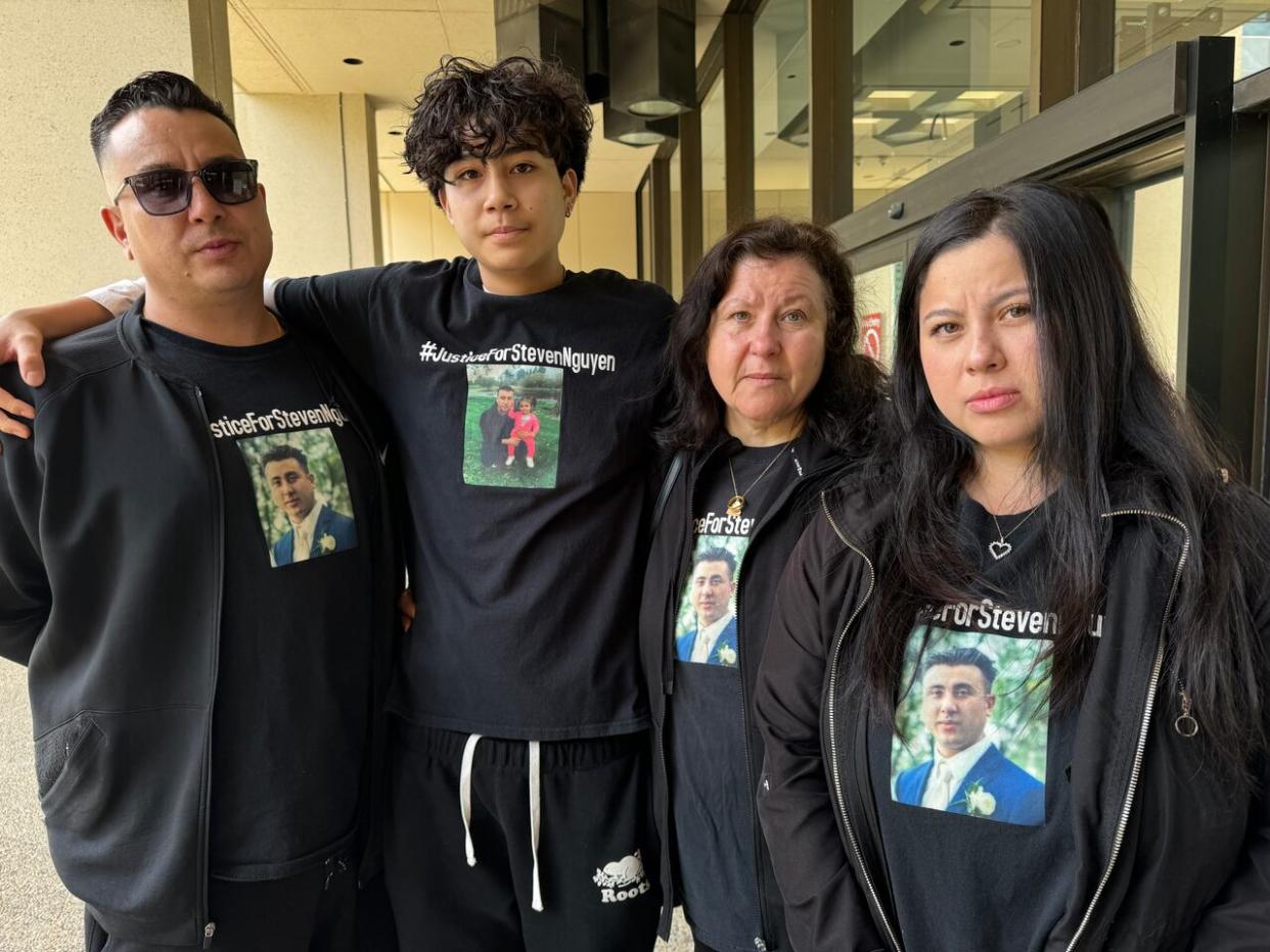 From left, Steven Nguyen's brother, nephew, mother and sister outside the Edmonton courthouse on May 15, 2024. (Madeline Smith/CBC - image credit)