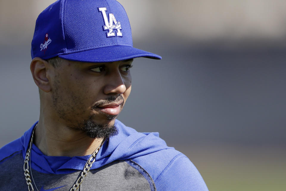 Los Angeles Dodgers outfielder Mookie Betts looks on during spring baseball training Monday, Feb. 17, 2020, in Phoenix. (AP Photo/Gregory Bull)