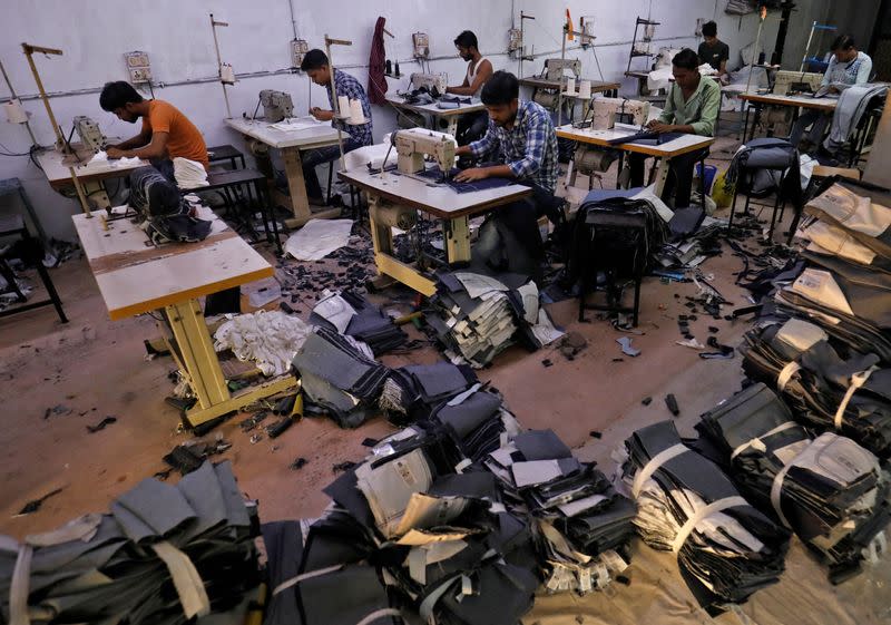Workers sew jeans and cotton trousers in a garments manufacturing unit in Ahmedabad