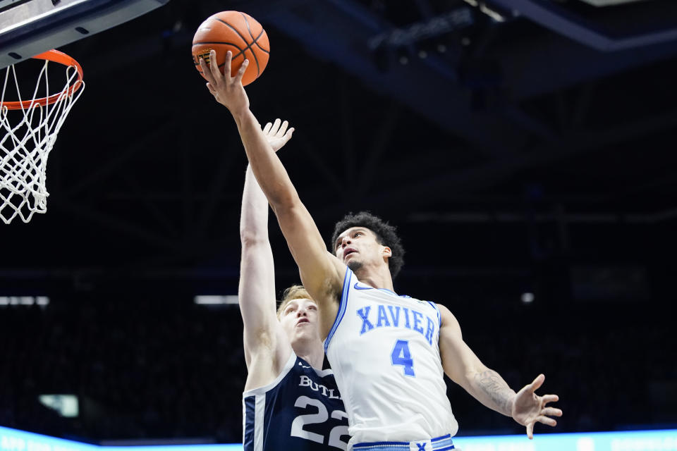 Xavier forward Cesare Edwards (4) shoots as Butler forward Connor Turnbull (22) defends during the first half of an NCAA college basketball game, Saturday, March 4, 2023, in Cincinnati. (AP Photo/Joshua A. Bickel)
