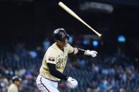 Arizona Diamondbacks' Carson Kelly flips his bat away as he flies out against the Los Angeles Dodgers during the third inning of a baseball game Sunday, Sept. 26, 2021, in Phoenix. (AP Photo/Ross D. Franklin)