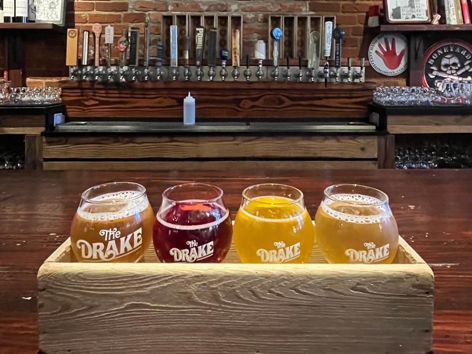 flight of beer in front of the bar at the drake in victoria canada