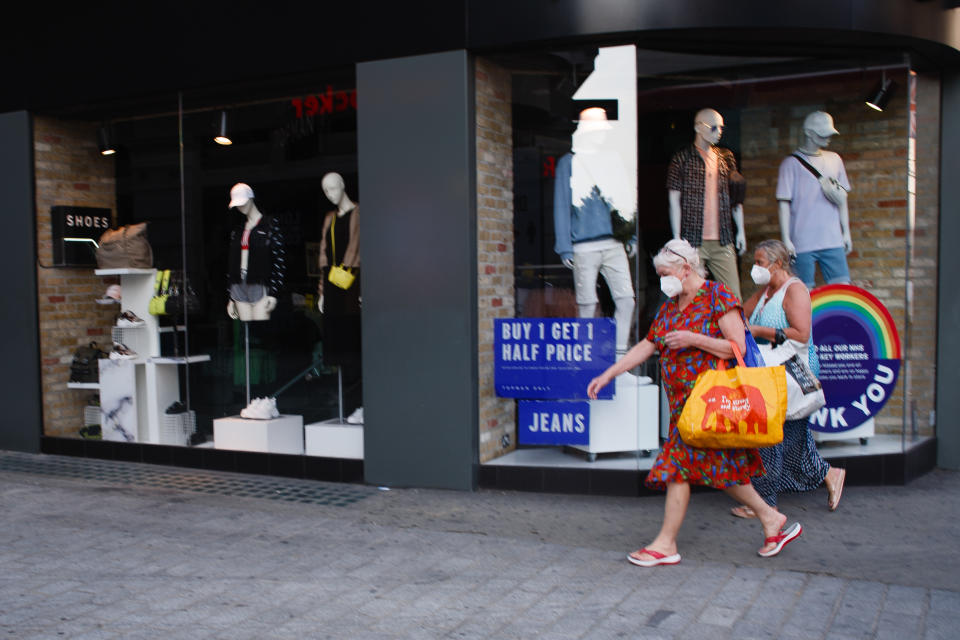 A pair of women wearing face masks turn onto Old Quebec Street from Oxford Street in London, England, on June 23, 2020. British Prime Minister Boris Johnson announced today that the next stage of lockdown easing in England would proceed on schedule, with pubs, restaurants, hotels, hairdressers, theatres, cinemas, museums, galleries, libraries, theme parks and zoos allowed to reopen from July 4. The two-metre social distancing rule is also to be halved from the same date, with people encouraged to take additional mitigation actions, such as wearing face coverings, when close together. The change, to what is being dubbed 'one-metre plus', is seen as key to the survival of the hospitality sector. (Photo by David Cliff/NurPhoto via Getty Images)