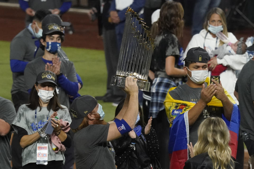 Los Angeles Dodgers third baseman Justin Turner celebrates with the trophy after defeating the Tampa Bay Rays 3-1 to win the baseball World Series in Game 6 Tuesday, Oct. 27, 2020, in Arlington, Texas. (AP Photo/Tony Gutierrez)