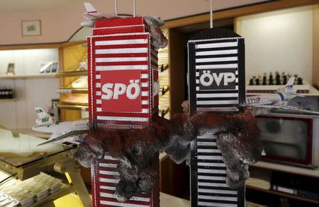 A cake depicting Austria's main political parties as New York's twin towers being attacked by opposition party aircraft is seen in a cafe in Vienna, Austria, May 5, 2015. REUTERS/Leonhard Foeger