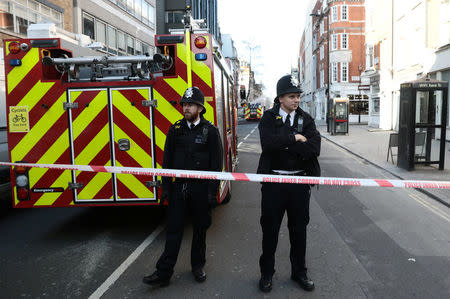 Police prevent access to the area as firefighters work to control a fire at a construction site in central London, Britain, February 17, 2018. REUTERS/Simon Dawson