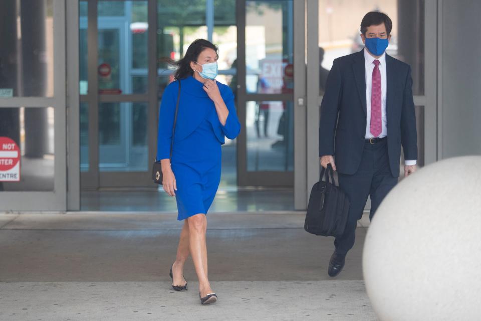 Delaware state Auditor Kathy McGuiness, left, leaves the New Castle County Courthouse with her attorney Steve Wood Tuesday, Oct. 12, 2021. McGuiness was indicted Monday on criminal charges that she hired and supervised her daughter in a do-nothing state job, that she circumvented state contracting laws to shield public payments to a political campaign group from regulator scrutiny and that she spied on and discriminated against employees who questioned her conduct.