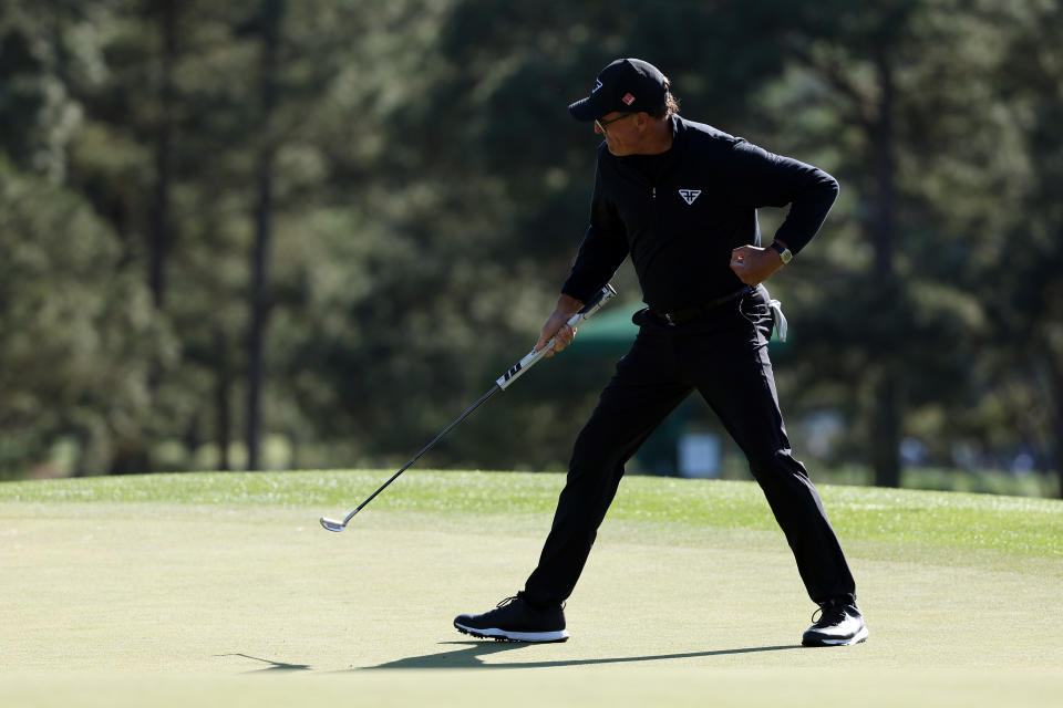 Mickelson holes his putt at the 18th hole and fist pumps