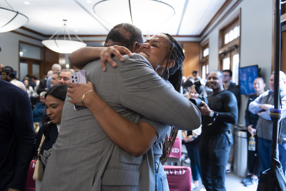 New Georgetown NCAA college basketball head coach Ed Cooley hugs his daughter, Olivia Cooley, at an introductory press conference in Washington, Wednesday, March 22, 2023. (AP Photo/Cliff Owen)