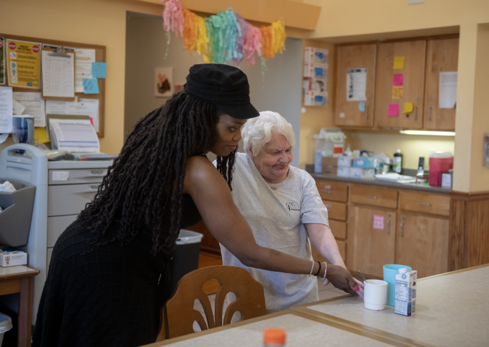 Direct support professional Jameca England helps Carol Carter, 84, at an Independence of Portage County facility.