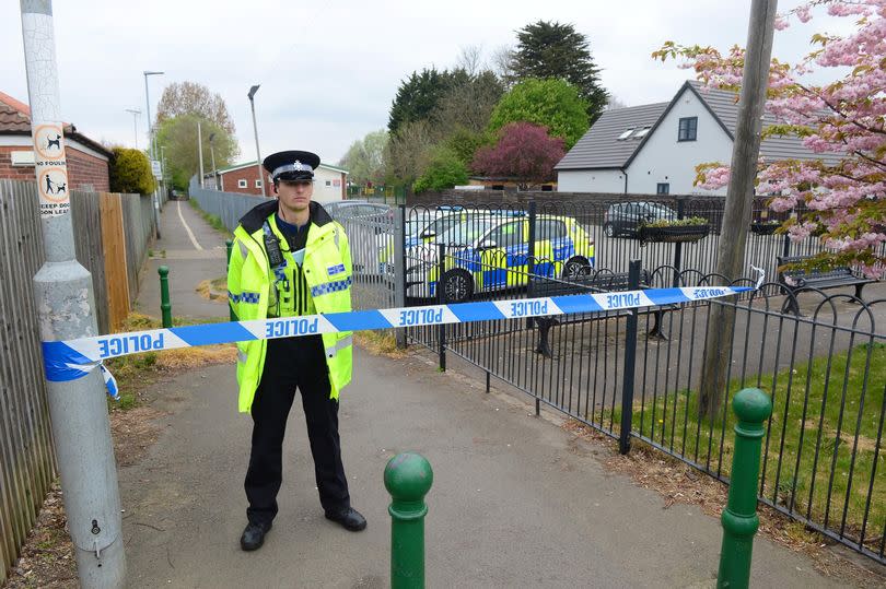 A PCSO stands guard at the police cordon at the cycle and foot path which runs from Peaks Parkway to Station Road, New Waltham -Credit:Rick Byrne / GrimsbyLive