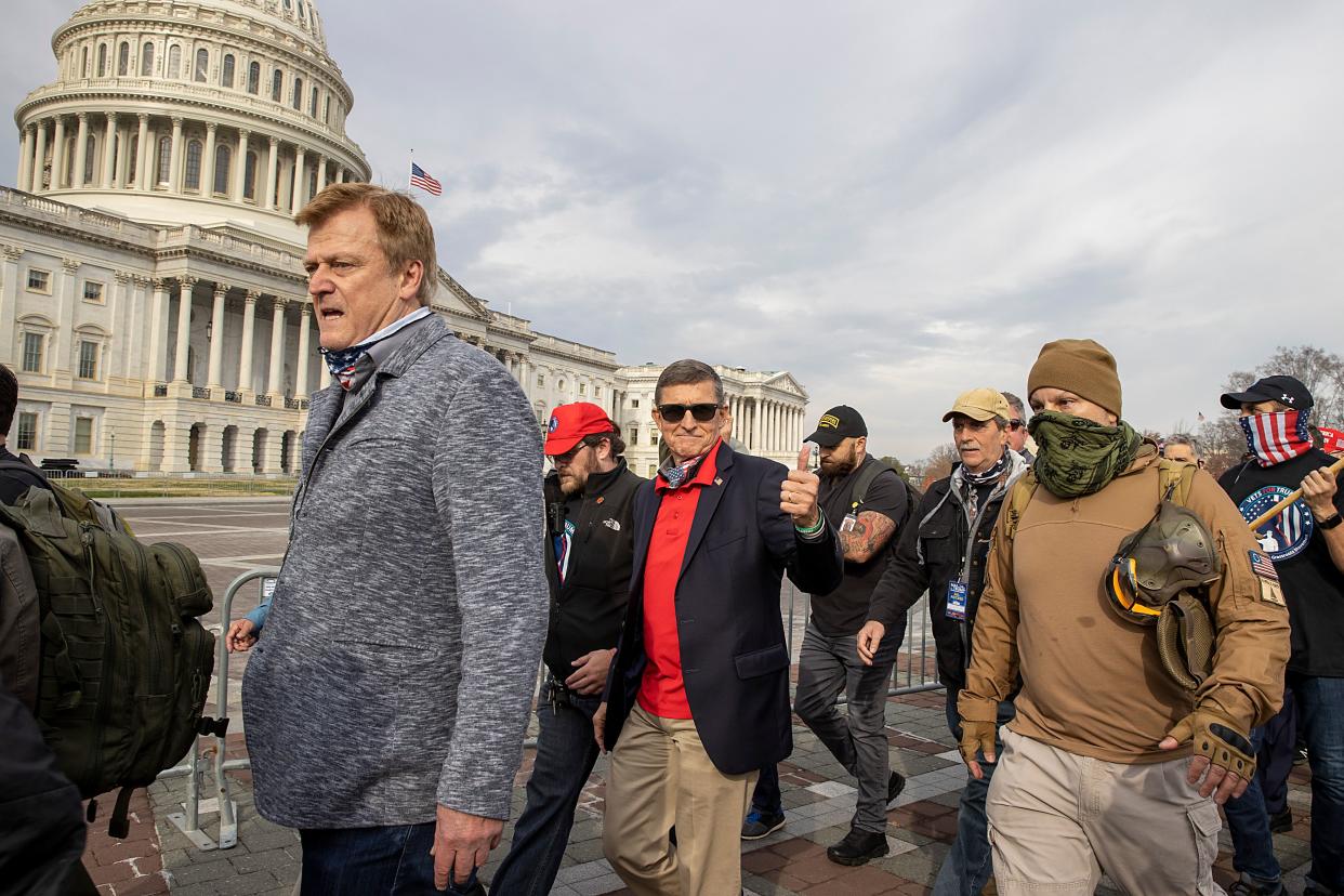 Flynn departs the Dec. 12, 2020, protest where he said Trump supporters trying to flip the election results were fighting &ldquo;a spiritual battle for the heart and soul of this country.&rdquo; (Photo: Tasos Katopodis/Getty Images)