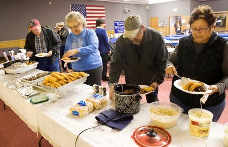 Supporters serve themselves from a buffet during a campaign dinner for Three Affiliated Tribes council chairman candidate Damon Williams on the Fort Berthold Reservation in North Dakota, November 1, 2014. REUTERS/Andrew Cullen