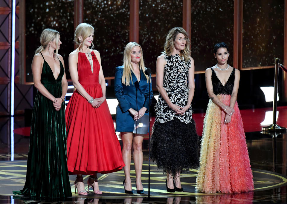 The cast presenting an award onstage