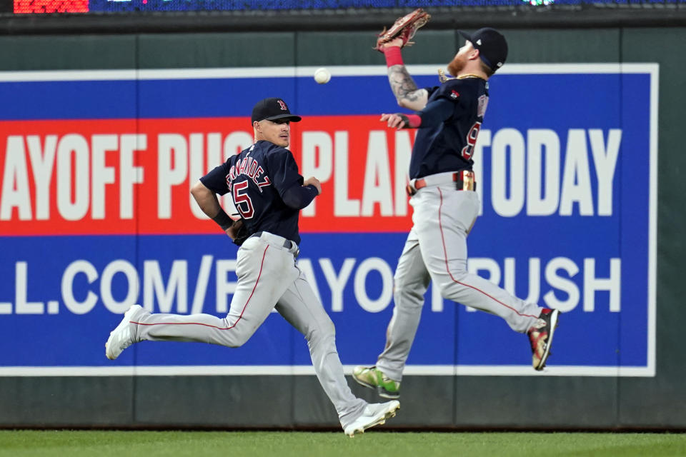 Boston Red Sox right fielder Alex Verdugo, right, commits an error attempting to make the catch on a ball hit by Minnesota Twins' Carlos Correa during the fifth inning of a baseball game Tuesday, Aug. 30, 2022, in Minneapolis. (AP Photo/Abbie Parr)