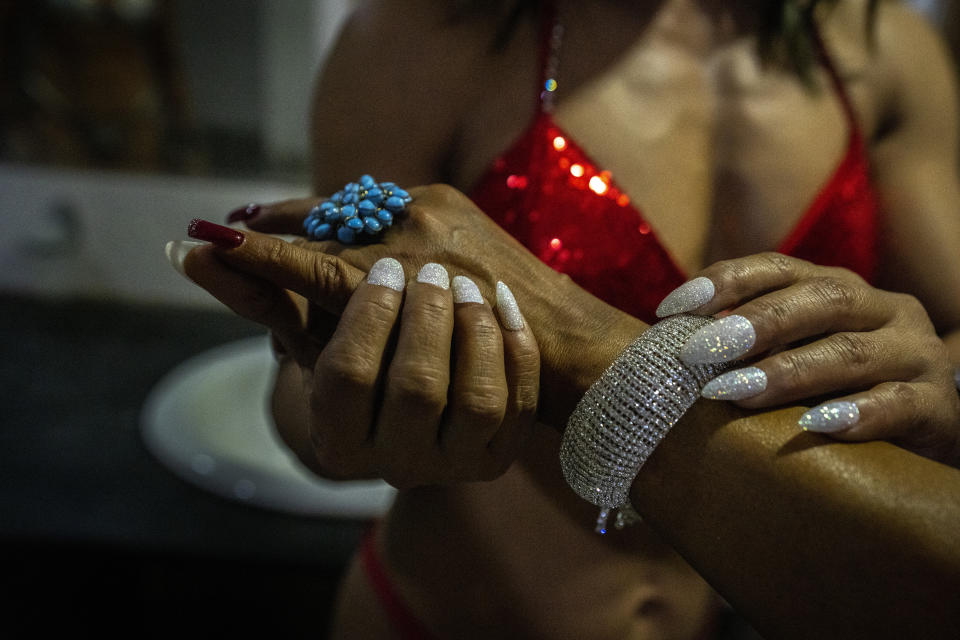 Female body builders prepare backstage to participate in the first national Miss Saraighat Body Building Championship in Gauhati, northeastern Assam state, India, Saturday, April 2, 2022. (AP Photo/Anupam Nath)