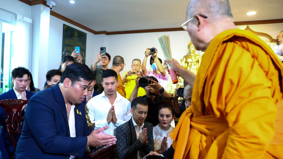 Vacharaesorn Vivacharawongse is blessed by a Buddhist monk during a religious ceremony at Wat Yannawa temple in Bangkok, Thailand, on August 10. - Athit Perawongmetha/Reuters