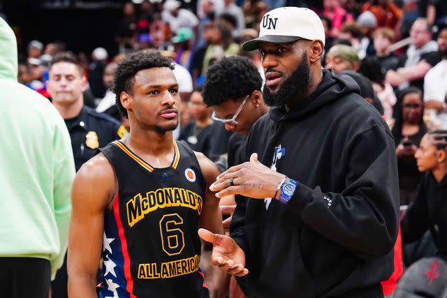 <p>Alex Bierens de Haan/Getty </p> Bronny James #6 of the West team talks to LeBron James after the 2023 McDonald's High School Boys All-American Game at Toyota Center on March 28, 2023 in Houston, Texas.