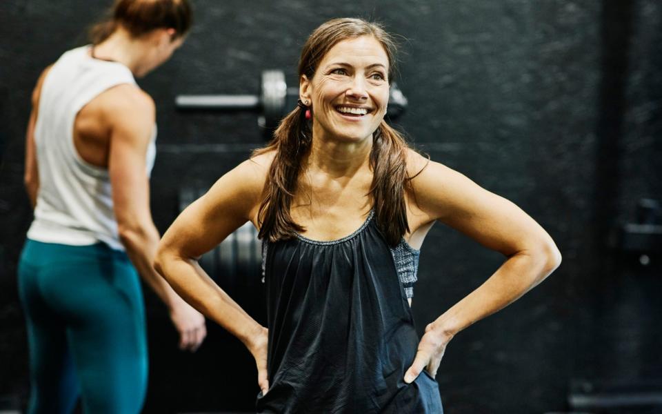 Woman resting during workout in gym - Thomas Barwick