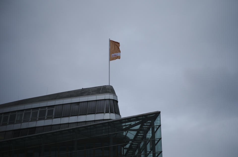A flag of Germany's Christian Democratic Union party, CDU, the party of Chancellor Angela Merkel, waves in the wind on top of the party's headquarters in Berlin, Germany, Sunday, March 14, 2021. Regional election in federal German states Baden Wuerttemberg and Rhineland-Palatinate are held today. (AP Photo/Markus Schreiber, Pool)