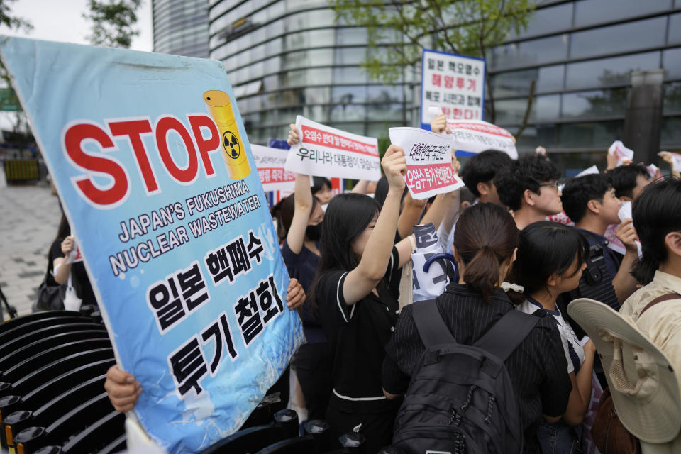 Protesters hold signs during a rally to denounce to release treated radioactive water into the sea from the damaged Fukushima nuclear power plant, outside of a building which houses Japanese Embassy, in Seoul, South Korea, Thursday, Aug. 24, 2023. The operator of the tsunami-wrecked Fukushima Daiichi nuclear power plant says it has begun releasing its first batch of treated radioactive water into the Pacific Ocean — a controversial step, but a milestone for Japan's battle with the growing radioactive water stockpile. (AP Photo/Lee Jin-man)
