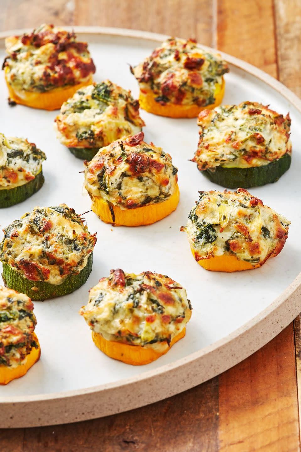 <p>These little guys are scary addictive. Just as the courgette becomes tender, the cheese is getting melty and delicious. </p><p>Get the <a href="https://www.delish.com/uk/cooking/recipes/a33664100/spinach-artichoke-zucchini-bites-recipe/" rel="nofollow noopener" target="_blank" data-ylk="slk:Spinach Artichoke Courgette Bites;elm:context_link;itc:0;sec:content-canvas" class="link ">Spinach Artichoke Courgette Bites</a> recipe.<br></p>