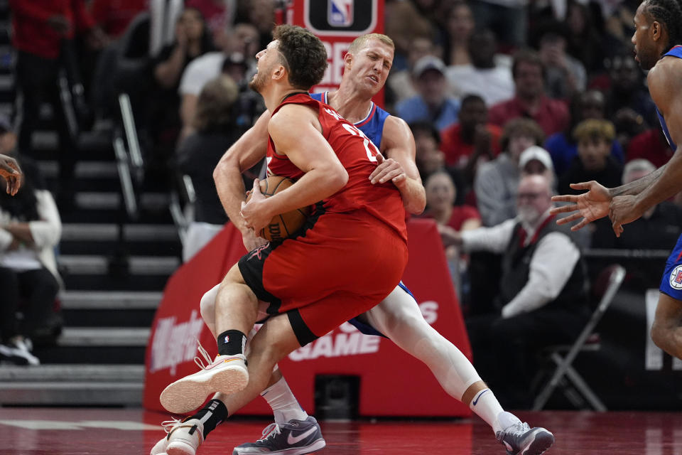 Houston Rockets' Alperen Sengun (28) is fouled by Los Angeles Clippers' Mason Plumlee during the second half of an NBA basketball game Wednesday, March 6, 2024, in Houston. The Clippers won 122-116. (AP Photo/David J. Phillip)
