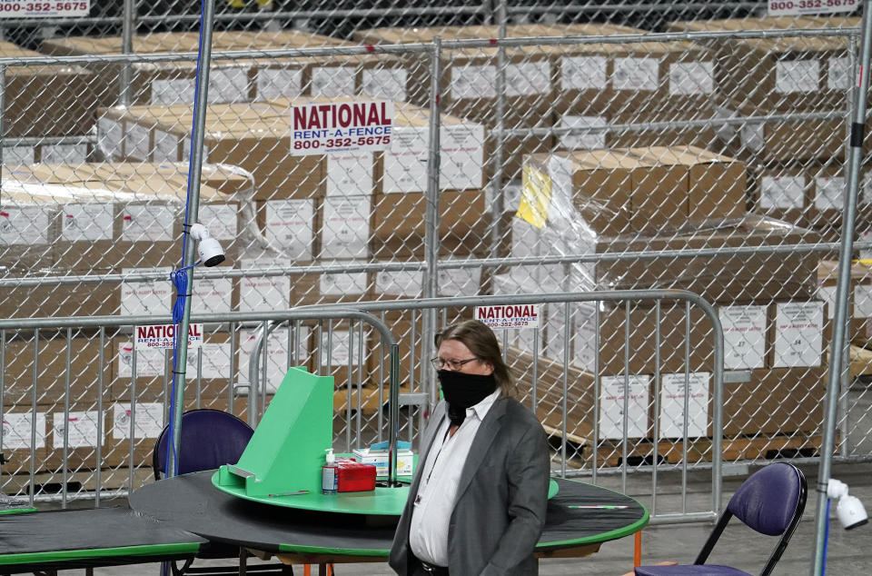 Maricopa County ballots cast in the 2020 general election are being examined and recounted by contractors working for Florida-based company, Cyber Ninjas, who was hired by the Arizona State Senate at Veterans Memorial Coliseum in Phoenix, Thursday, April 29, 2021. (Rob Schumacher/The Arizona Republic via AP, Pool)