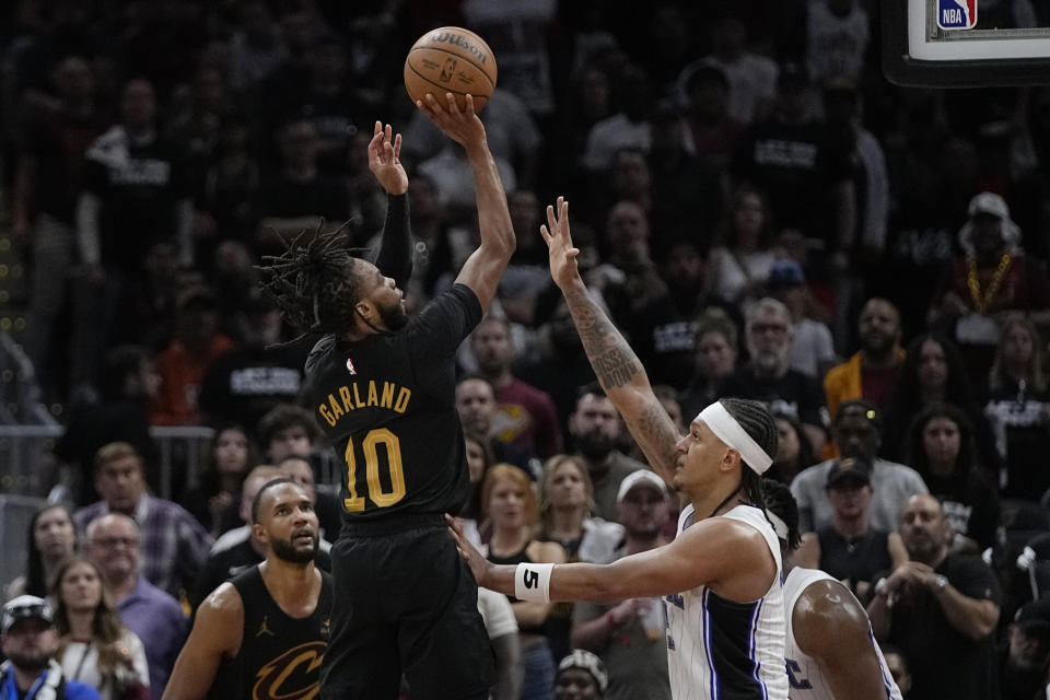 Cleveland Cavaliers guard Darius Garland (10) shoots over Orlando Magic forward Paolo Banchero in the second half of Game 7 of an NBA basketball first-round playoff series, Sunday, May 5, 2024, in Cleveland. (AP Photo/Sue Ogrocki)