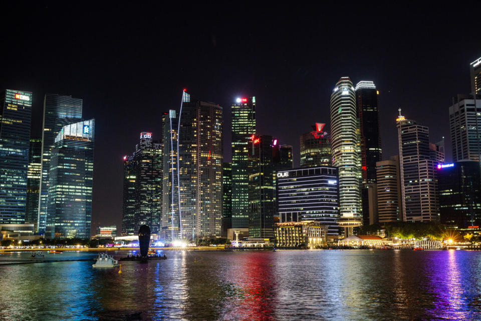 Buildings stand illuminated at night in the central business district of Singapore. (Photo: Getty Images)