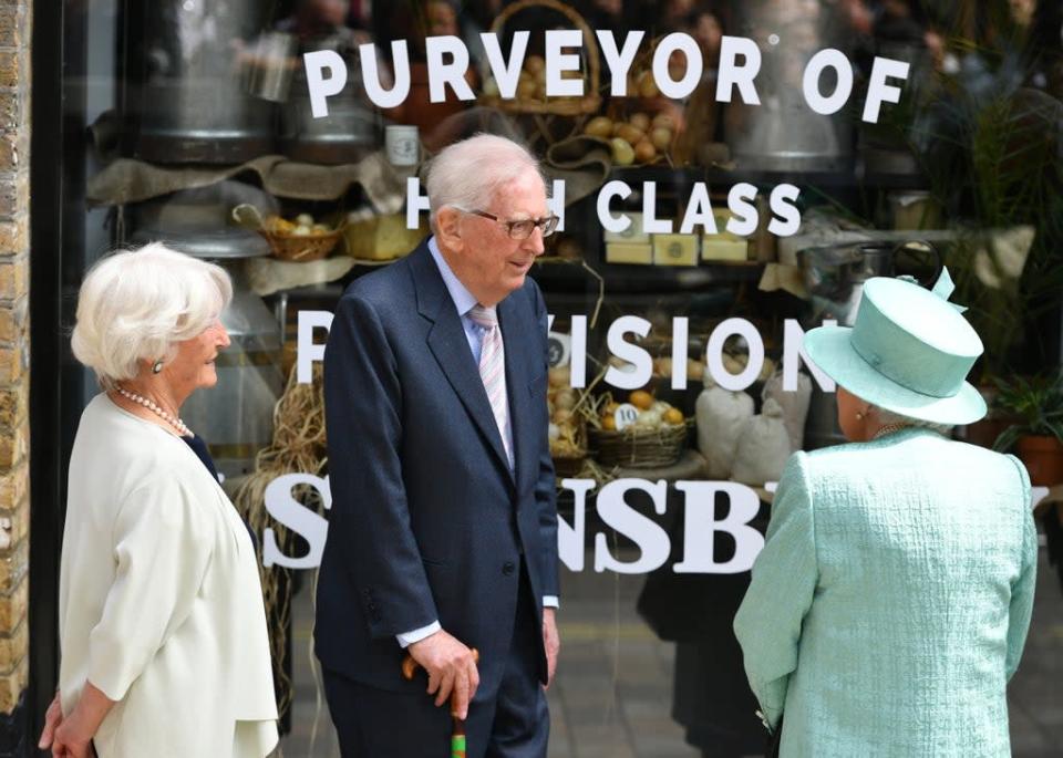 Queen Elizabeth II talks to Lord Sainsbury and his wife outside a replica of one of the original Sainsbury&#x002019;s stores at Covent Garden, London (Dominic Lipinski/PA Archive) (PA Archive)