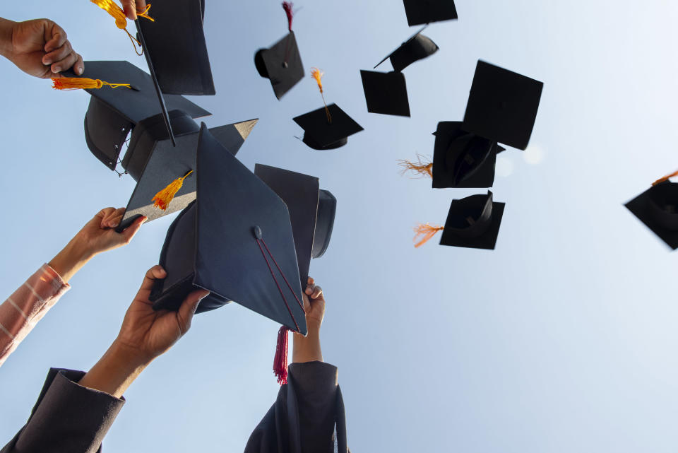 Graduation caps being thrown in the air