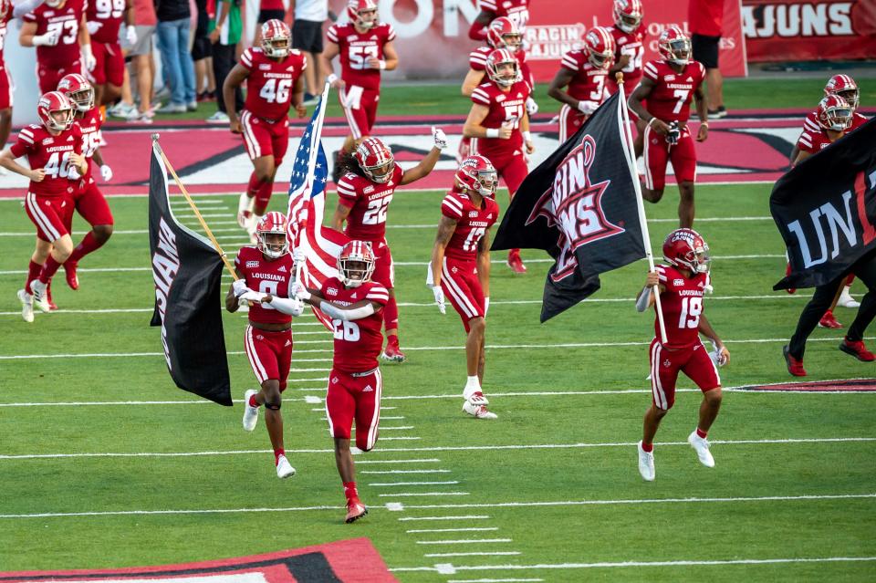 Bowl-bound UL, shown taking the field before a win over Appalachian State earlier this season, visits Liberty on Saturday.