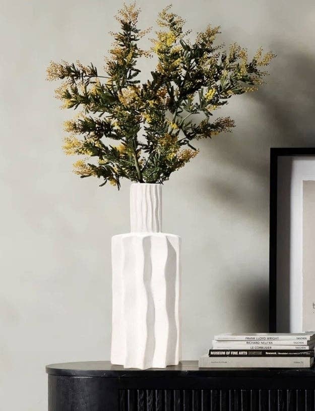 Vase with yellow flowers on a table